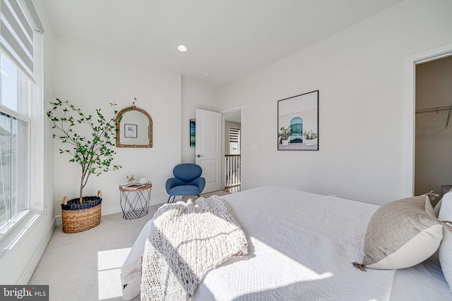 carpeted bedroom with multiple windows and recessed lighting