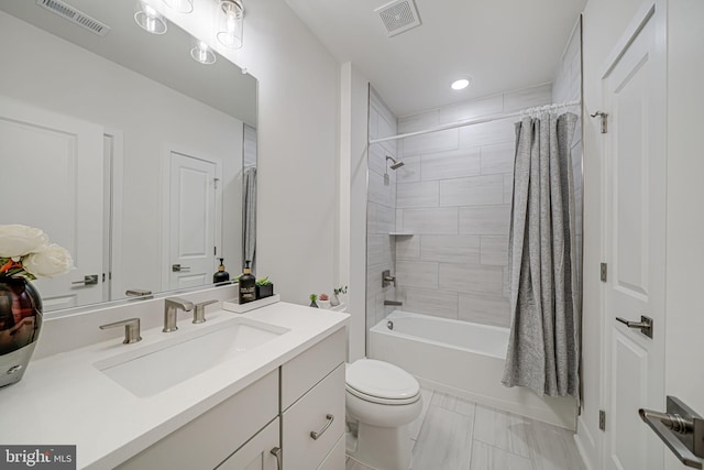 full bath with visible vents, shower / tub combo with curtain, vanity, and toilet