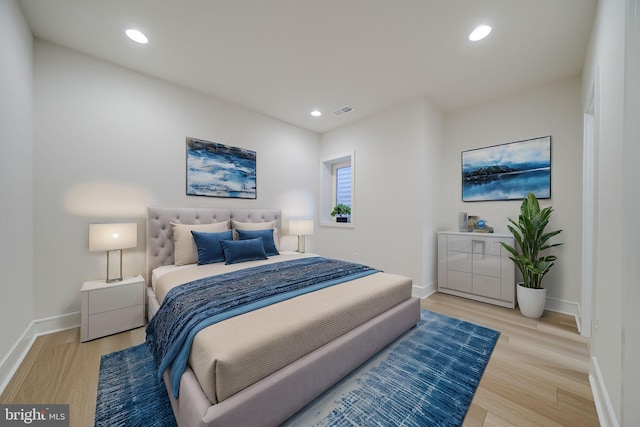 bedroom featuring wood finished floors, visible vents, and recessed lighting