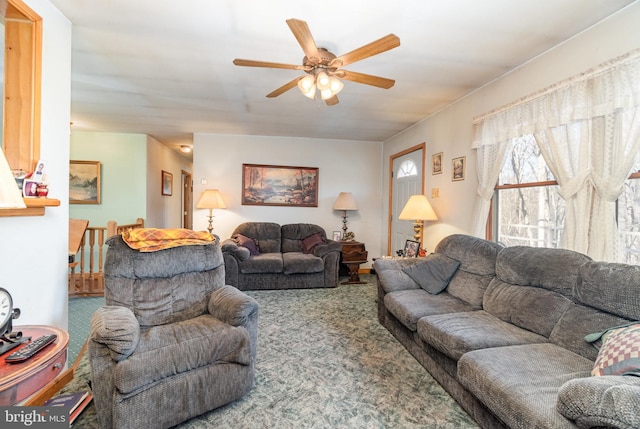 carpeted living room with ceiling fan