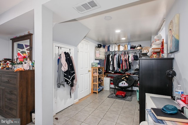 walk in closet featuring tile patterned flooring and visible vents