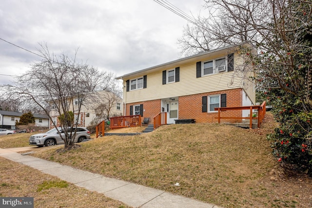 view of front of property featuring brick siding and a front yard