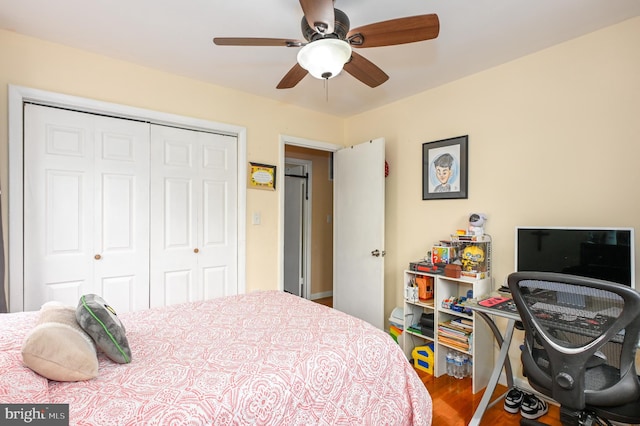 bedroom featuring a closet, wood finished floors, and a ceiling fan