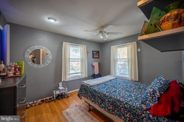 bedroom with a ceiling fan and wood finished floors