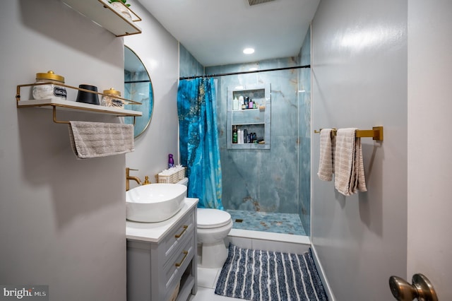 bathroom featuring curtained shower, visible vents, vanity, and toilet