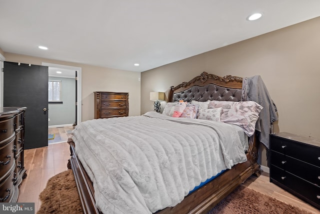 bedroom with recessed lighting, baseboards, and wood finished floors