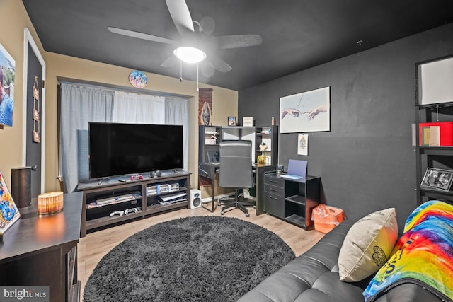 living area featuring wood finished floors and a ceiling fan