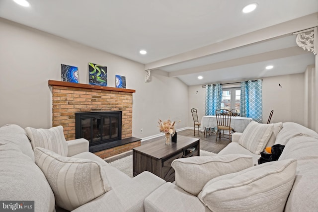 living area with recessed lighting, a fireplace, baseboards, and wood finished floors