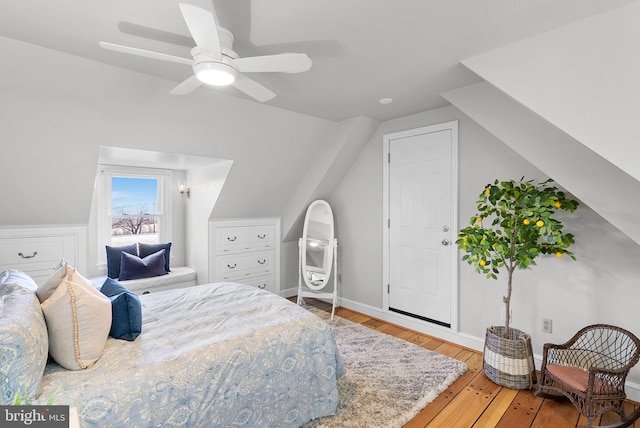 bedroom with baseboards, ceiling fan, vaulted ceiling, and hardwood / wood-style flooring