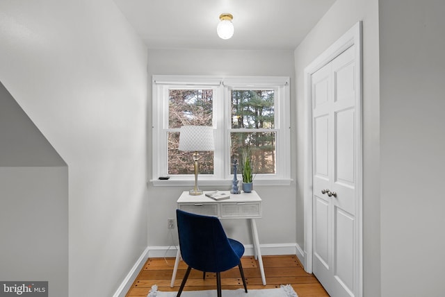 office space with wood finished floors and baseboards