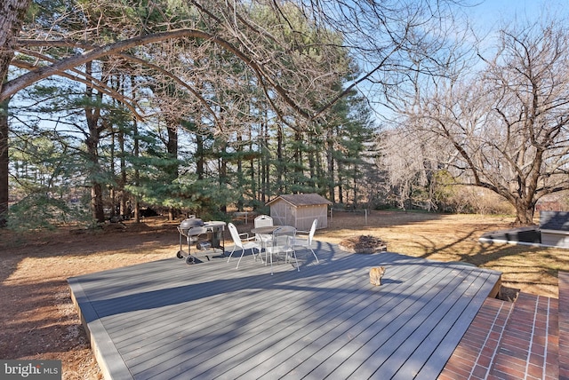 deck with an outbuilding and a storage unit