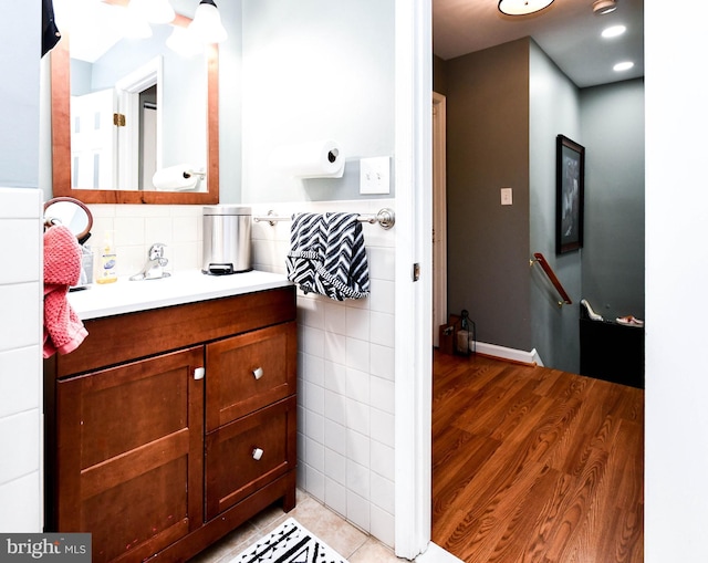 bathroom featuring tile walls, tile patterned flooring, and vanity