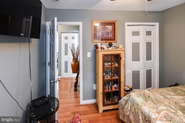bedroom featuring baseboards and light wood-style floors