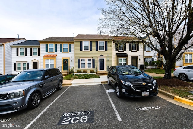 townhome / multi-family property featuring uncovered parking and a residential view