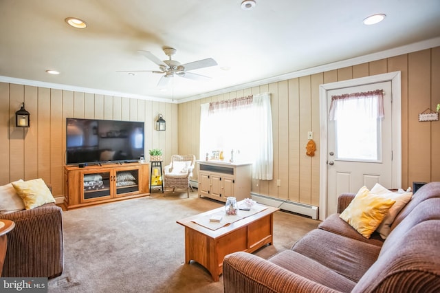 carpeted living area featuring ceiling fan, ornamental molding, baseboard heating, and recessed lighting