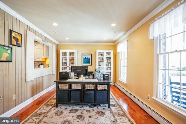 home office with baseboards, wood finished floors, crown molding, a baseboard heating unit, and recessed lighting