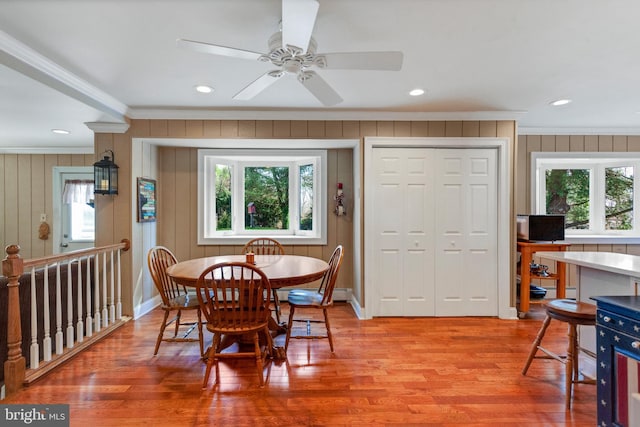 dining area featuring light wood-style floors, recessed lighting, crown molding, and baseboards