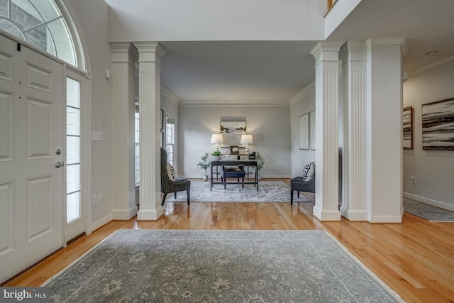 entryway featuring ornamental molding and ornate columns