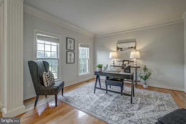 office with baseboards, wood finished floors, and crown molding