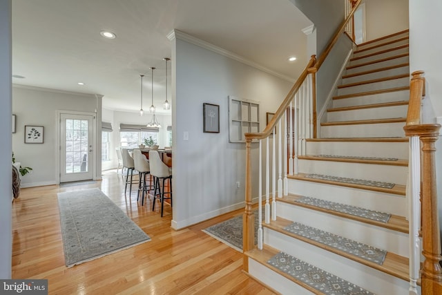 stairs with recessed lighting, baseboards, crown molding, and wood finished floors