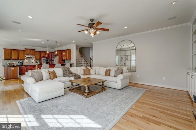 living room featuring baseboards, stairway, ornamental molding, light wood-style floors, and recessed lighting