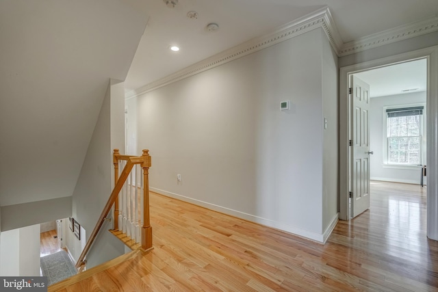 corridor with baseboards, wood finished floors, and an upstairs landing