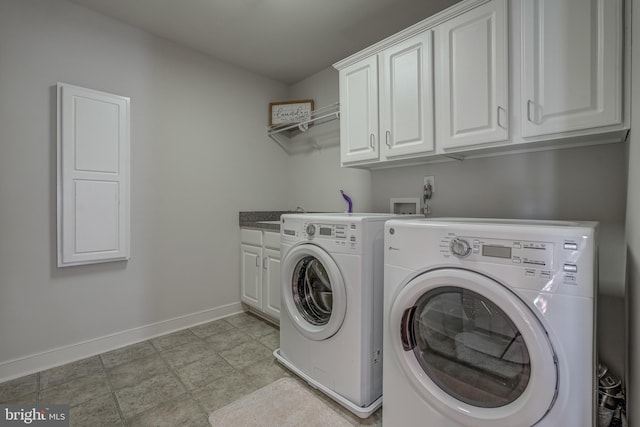 clothes washing area with separate washer and dryer, cabinet space, and baseboards