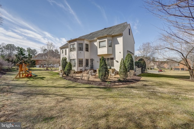 back of property with a patio, a lawn, and a playground