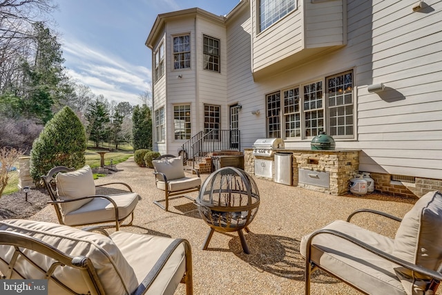 view of patio featuring exterior kitchen and a grill