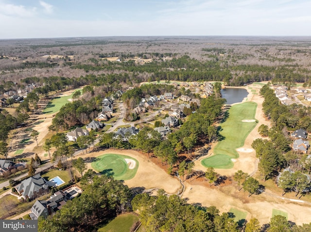 aerial view with golf course view and a water view