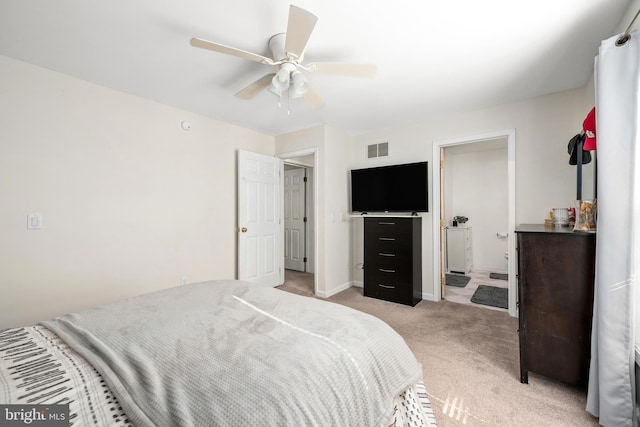 bedroom featuring connected bathroom, light carpet, a ceiling fan, visible vents, and baseboards