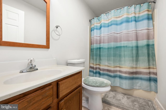 bathroom featuring toilet, curtained shower, and vanity