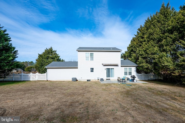 rear view of house with a yard, a patio area, a fenced backyard, and central air condition unit