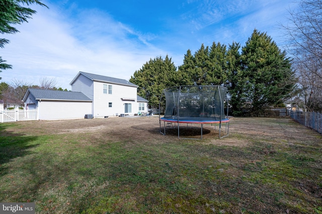 view of yard featuring a trampoline and a fenced backyard