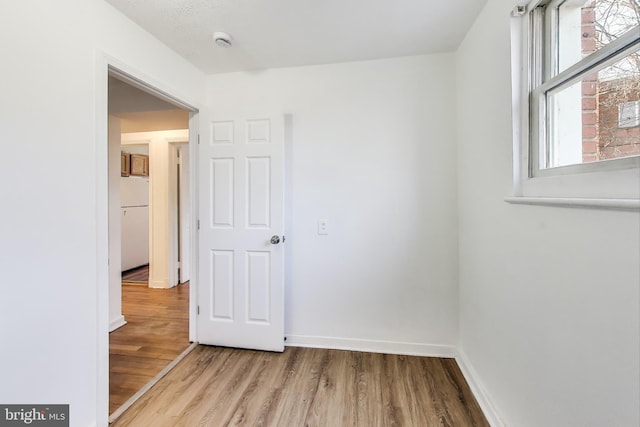 unfurnished room featuring wood finished floors and baseboards