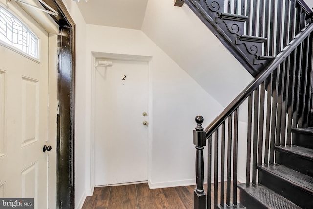 foyer featuring stairs and wood finished floors