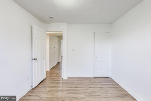 unfurnished bedroom featuring baseboards and light wood finished floors