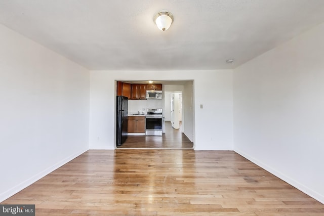 unfurnished living room with light wood-type flooring