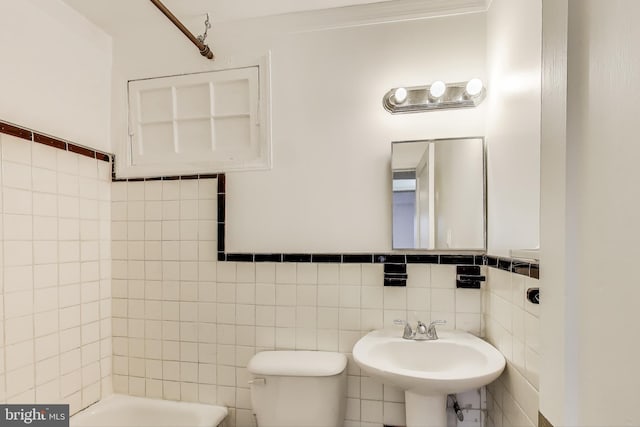 full bathroom with a tub to relax in, toilet, a sink, tile walls, and walk in shower