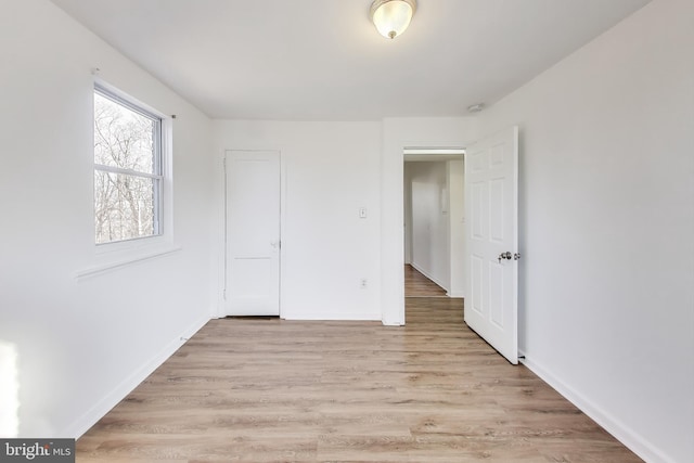 unfurnished bedroom featuring light wood finished floors and baseboards