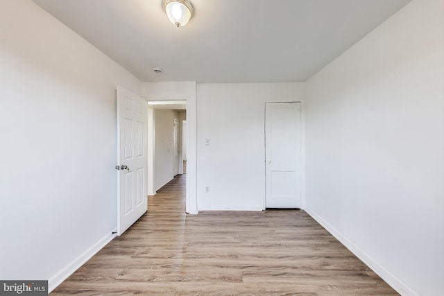 unfurnished bedroom with light wood-style floors and baseboards