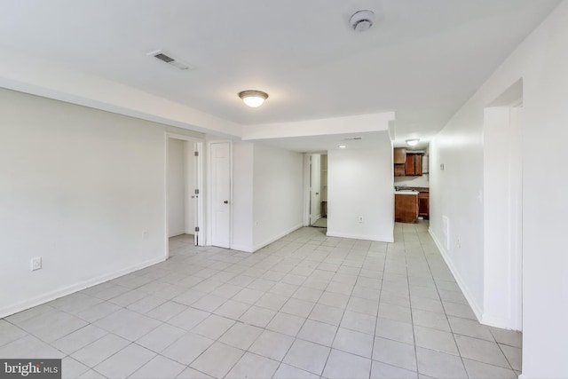 unfurnished room featuring visible vents, baseboards, and light tile patterned floors