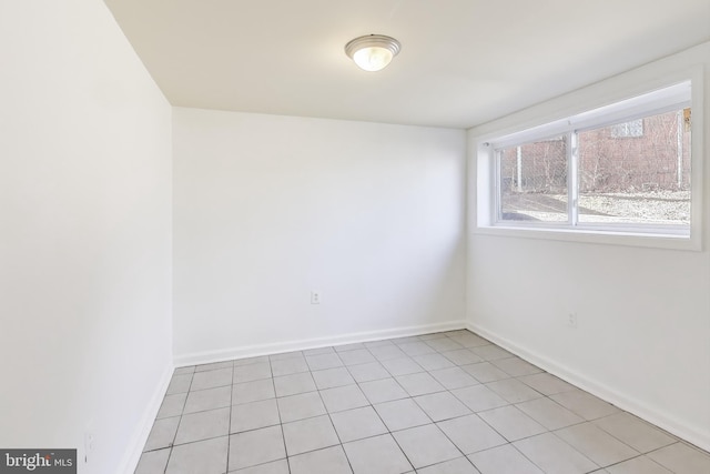 spare room with baseboards