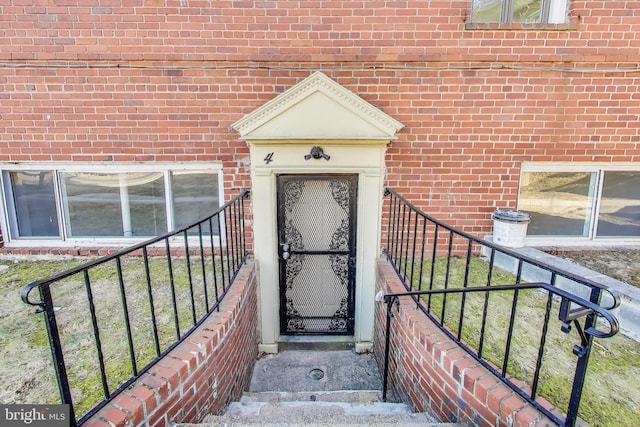 doorway to property featuring brick siding