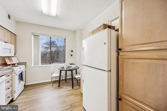 kitchen with white appliances, baseboards, visible vents, a textured ceiling, and light wood-style floors