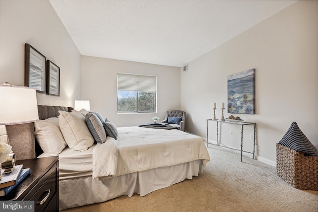 bedroom with carpet, visible vents, baseboards, and a textured ceiling