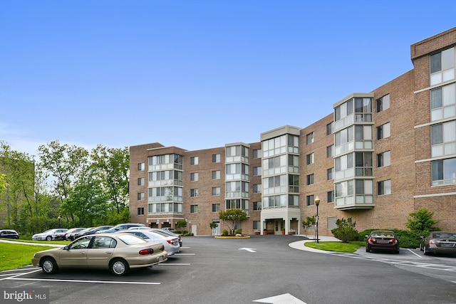 view of property featuring uncovered parking