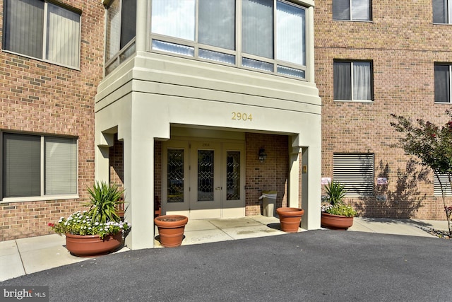 doorway to property with french doors and brick siding