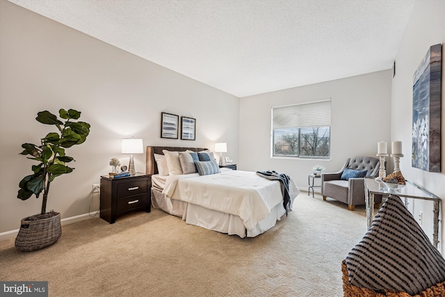 bedroom with light carpet, baseboards, and a textured ceiling