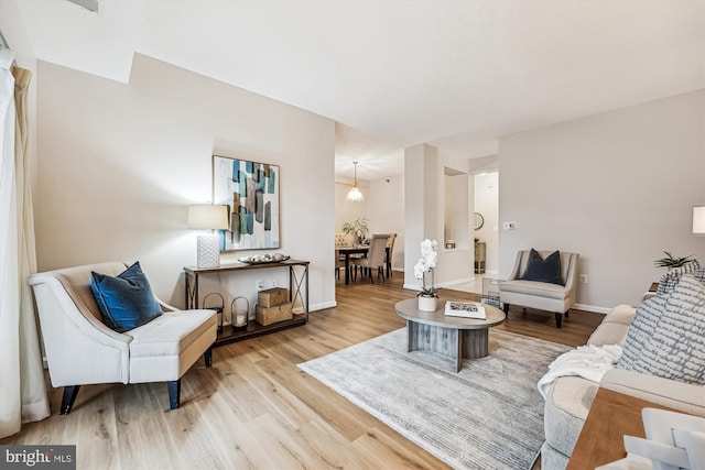 living room with light wood finished floors and baseboards